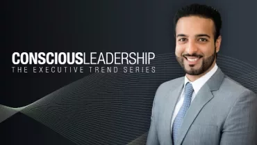 Man in suit smiling next to text 'Conscious Leadership' on dark background.